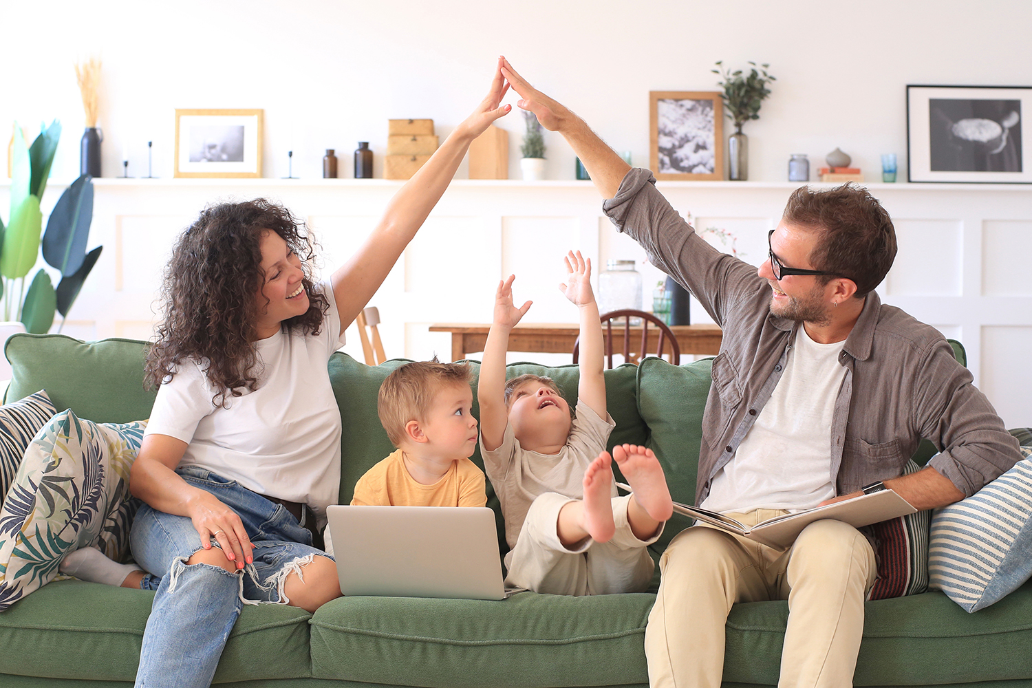 Young beautiful happy family relaxing on the sofa at home.